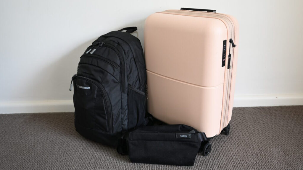 A backpack, suitcase and crossbody bag.