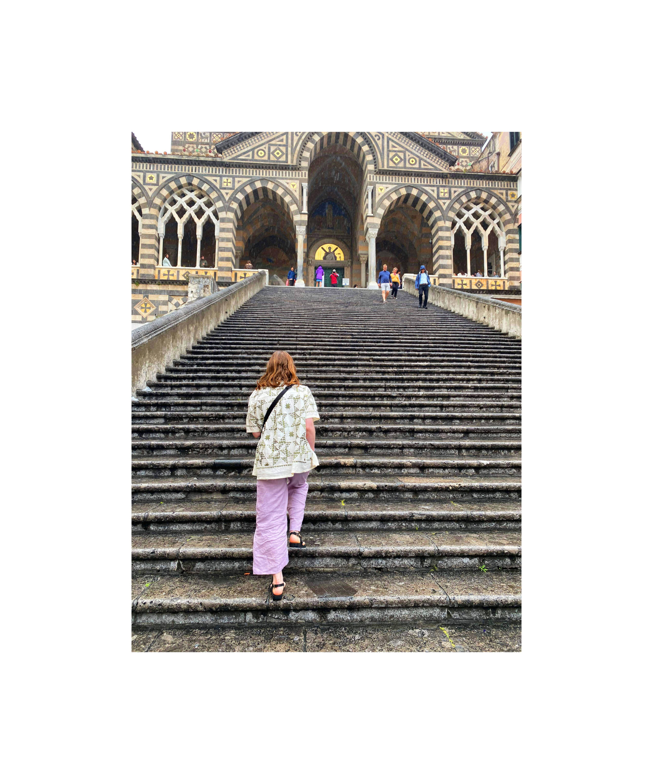 Women walking up the stairs of the Amalfi Cathedral. 